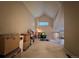 Bright bonus room with vaulted ceiling, neutral walls, large boxes, and one small window at 4933 S Carson St # 212, Aurora, CO 80015