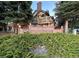 Landscaped entrance to the Sterling Commons community with a brick sign and mature trees at 4933 S Carson St # 212, Aurora, CO 80015