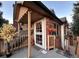 A charming front porch entrance featuring a welcoming front door and string lights creating a cozy ambiance at 4933 S Carson St # 212, Aurora, CO 80015