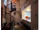 Open-concept living space featuring spiral staircase and view of the kitchen at 4933 S Carson St # 212, Aurora, CO 80015