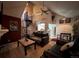 Inviting living room featuring a spiral staircase, vaulted ceilings, and a view into the adjacent kitchen at 4933 S Carson St # 212, Aurora, CO 80015