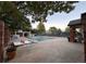 A community pool with a partial cover, surrounded by comfortable seating and mature trees at 4933 S Carson St # 212, Aurora, CO 80015