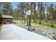 Backyard patio with playground, basketball hoop, and well-maintained landscaping at 26499 West St, Conifer, CO 80433