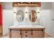 Modern bathroom featuring a double vanity with unique sliding door cabinets and stylish fixtures at 26499 West St, Conifer, CO 80433