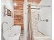 Bright bathroom featuring a freestanding tub, walk-in shower and decorative shelving at 26499 West St, Conifer, CO 80433