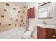 Bathroom features tiled shower and tub, cherry vanity and tiled backsplash at 26499 West St, Conifer, CO 80433
