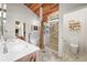 Luxury bathroom with a freestanding tub, walk-in shower, and dual sink vanity, offering a spa-like experience at 26499 West St, Conifer, CO 80433
