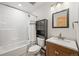 Bright bathroom with bathtub, shower, and vanity with wood cabinet at 26499 West St, Conifer, CO 80433