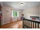 Well-lit bedroom with hardwood floors and views of the outdoors at 26499 West St, Conifer, CO 80433