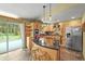 Stylish kitchen with a granite island, stainless steel appliances, and views of the serene outdoors at 26499 West St, Conifer, CO 80433