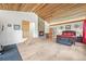 Main bedroom with fireplace, wooden ceiling, and steps up to ensuite bathroom at 26499 West St, Conifer, CO 80433