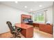 Inviting home office with custom wooden desk, cabinets, and view of the outdoors at 26499 West St, Conifer, CO 80433