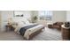 Stylishly furnished bedroom showcasing a comfortable bed, contemporary decor, and bright natural lighting at 760 N Deer Park St, Watkins, CO 80137