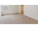 Clean bedroom with plush carpet, a window, and a view of the neighborhood at 760 N Deer Park St, Watkins, CO 80137