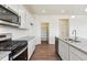 Modern kitchen with stainless steel appliances, granite countertops, and a convenient pantry at 760 N Deer Park St, Watkins, CO 80137