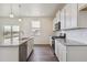 Bright kitchen with granite countertops, subway tile backsplash, and stainless steel appliances at 760 N Deer Park St, Watkins, CO 80137