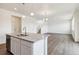 Open concept living room featuring an island with granite counters and modern lighting at 760 N Deer Park St, Watkins, CO 80137