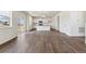 Open-concept living area flowing into the kitchen, showcasing laminate flooring and natural light at 760 N Deer Park St, Watkins, CO 80137