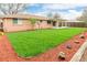 Expansive backyard with well-maintained lawn, wood mulch accents, and a cozy covered patio area at 8487 W 62Nd Pl, Arvada, CO 80004