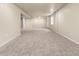 Spacious carpeted basement area with natural light offering versatility for recreation or storage at 8487 W 62Nd Pl, Arvada, CO 80004