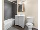 Contemporary bathroom featuring a vanity with a framed mirror and a tiled shower over a bathtub at 8487 W 62Nd Pl, Arvada, CO 80004