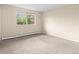 Bright bedroom with neutral carpet, a large window, and fresh paint providing ample natural light at 8487 W 62Nd Pl, Arvada, CO 80004
