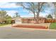 Charming single-story brick home with a manicured front yard and attached garage on a sunny day at 8487 W 62Nd Pl, Arvada, CO 80004