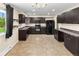 Updated kitchen with dark cabinets, modern appliances, and tile floors is ready for you to cook at 8487 W 62Nd Pl, Arvada, CO 80004