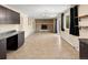 Large open-concept living area with a fireplace, tile flooring, and access to the backyard at 8487 W 62Nd Pl, Arvada, CO 80004