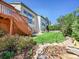 Expansive backyard features a well-maintained lawn, patio with seating, and a charming rock water feature at 10565 Kicking Horse Dr, Littleton, CO 80125