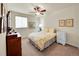 Comfortable bedroom with natural light from the window and a ceiling fan at 10565 Kicking Horse Dr, Littleton, CO 80125