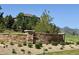 Stone monument for Chatfield Farms West in front of a hillside home at 10565 Kicking Horse Dr, Littleton, CO 80125