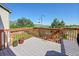 A deck with scenic views of the lake, mountains, and manicured backyard at 10565 Kicking Horse Dr, Littleton, CO 80125