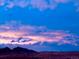 Beautiful dusk sky with clouds over the distant mountains and landscape at 10565 Kicking Horse Dr, Littleton, CO 80125
