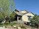 This house features a large front porch and well-maintained landscaping, creating an inviting curb appeal at 10565 Kicking Horse Dr, Littleton, CO 80125