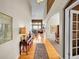 Bright foyer with hardwood floors leads to an elegant living space and dining area, showcasing the home's open layout at 10565 Kicking Horse Dr, Littleton, CO 80125
