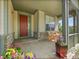 Charming front porch with stone accents, offering a cozy space with seating and colorful potted flowers at 10565 Kicking Horse Dr, Littleton, CO 80125