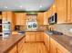 Well-lit kitchen with wooden cabinets, granite countertops, stainless steel appliances, and hardwood flooring at 10565 Kicking Horse Dr, Littleton, CO 80125