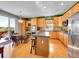 Bright eat-in kitchen features hardwood floors, center island, stainless steel appliances, and patio access at 10565 Kicking Horse Dr, Littleton, CO 80125