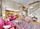 Elegant living room with high ceilings, grand staircase, and open flow to kitchen area at 10565 Kicking Horse Dr, Littleton, CO 80125