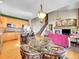 Open layout kitchen/living area with wood floors, island seating, and fireplace, perfect for gatherings at 10565 Kicking Horse Dr, Littleton, CO 80125