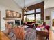 Spacious living room with a fireplace, large windows, and high ceilings, offering ample natural light and stunning views at 10565 Kicking Horse Dr, Littleton, CO 80125