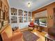 Cozy living room featuring built-in bookshelves, a comfortable seating area, and natural light from the window at 10565 Kicking Horse Dr, Littleton, CO 80125