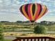 View of colorful hot air balloon over neighborhood from the house, highlighting community and visual appeal at 10565 Kicking Horse Dr, Littleton, CO 80125
