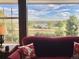 Scenic view from the living room showcasing a serene lake and lush greenery, bringing nature indoors at 10565 Kicking Horse Dr, Littleton, CO 80125