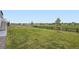Expansive backyard with lush grass, a wooden fence, a walking path, and views of the surrounding neighborhood at 7702 E 159Th Ave, Thornton, CO 80602
