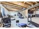 Unfinished basement with exposed beams, fitness equipment, and plenty of space for customization at 7702 E 159Th Ave, Thornton, CO 80602