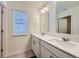 Modern bathroom with double vanity, white cabinets, and a large window offering natural light at 7702 E 159Th Ave, Thornton, CO 80602
