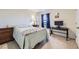 A cozy bedroom with a bed, side tables, and a desk with a television, decorated with a video game theme at 7702 E 159Th Ave, Thornton, CO 80602