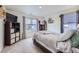 Well-lit bedroom with a large window, TV and shelving unit, and stylish decor at 7702 E 159Th Ave, Thornton, CO 80602
